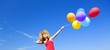 Brunette girl with colour balloons at blue sky background.