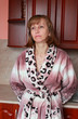 A woman stands near the kitchen