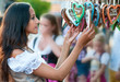 Young woman in Dirndl costume together with Gingerbread heart