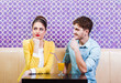 Cute young couple sitting at the table