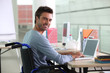 Man sitting at desk in wheelchair